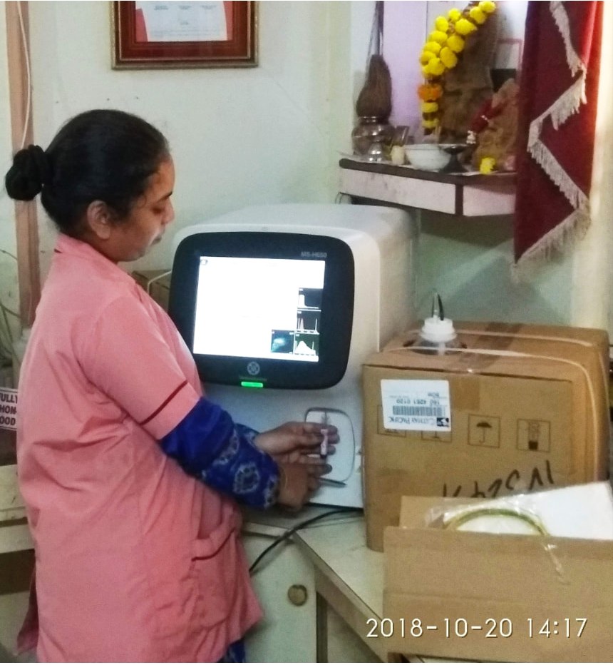 Om Lab Team Member Working With Diagnostic Equipment